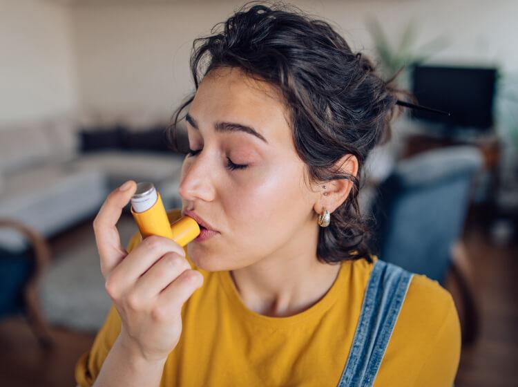 Woman using inhaler