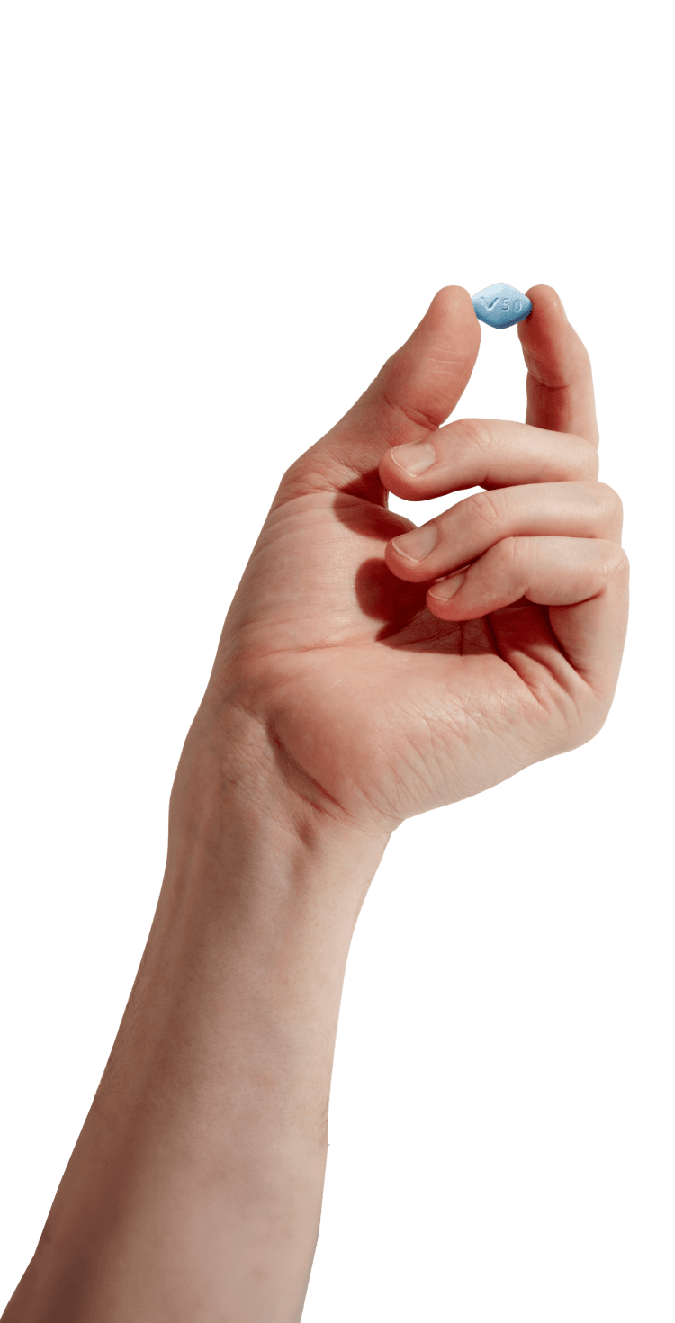 Hand holding a sildenafil pill