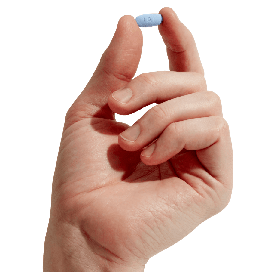 hand holding a blue pill